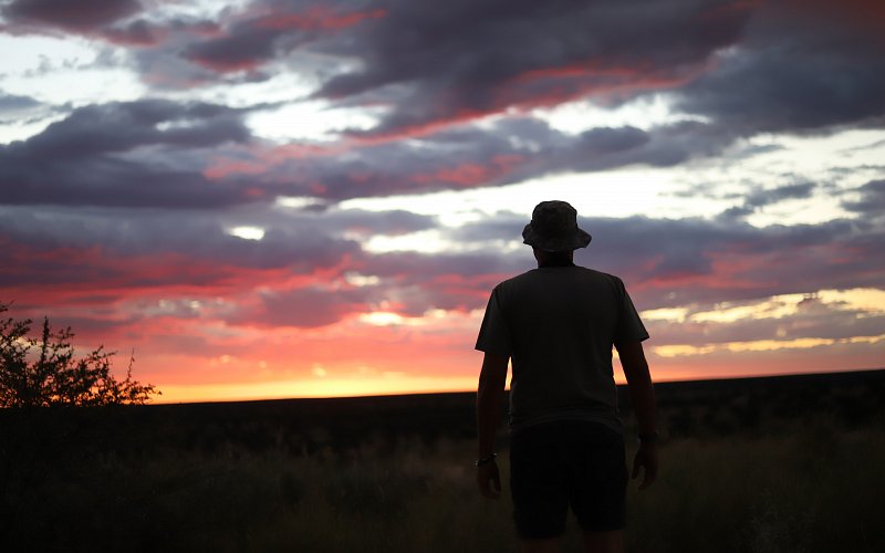 local-travel-namibia-car-rental-image-of-man-watching-the-sunset