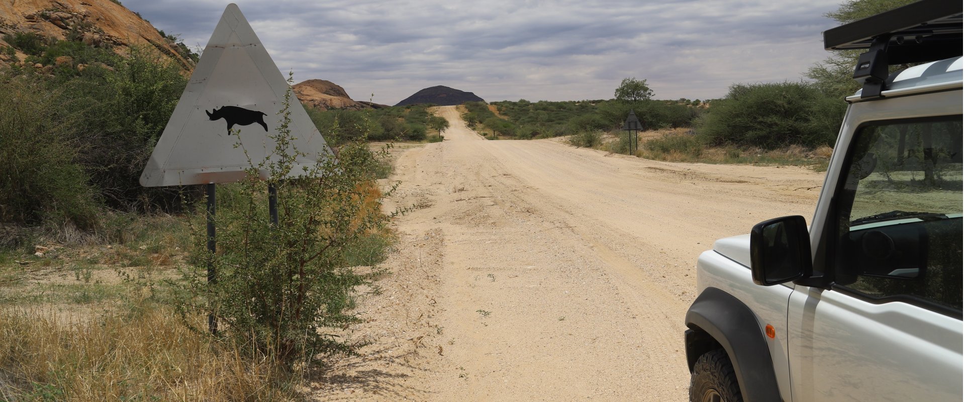 local-travel-namibia-car-rental-namibian-desert-road-with-a-sign